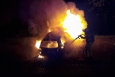 A fire officer attends to a burning car in Namur (Belga image)