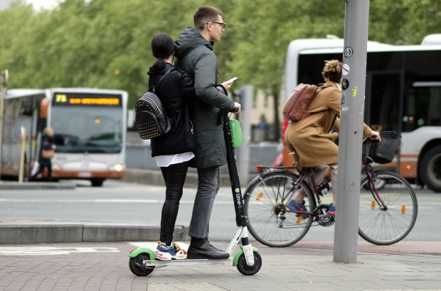 Illustration picture shows people riding the Lime-S moped scooter sharing system in Brussels, Friday 03 May 2019. (BELGA PHOTO ERIC LALMAND)