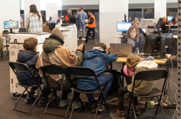 Ukrainians complete their registration at a center for the registration of Ukrainian refugees, at the Palace 8 hall of Brussels expo, Monday 14 March 2022. The center is opened to welcome Ukrainians fleeing their country after the Russian invasion. BELGA PHOTO JAMES ARTHUR GEKIERE
