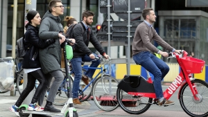 Illustration picture shows people riding scooters and bicycles in Brussels, Friday 03 May 2019. (BELGA PHOTO ERIC LALMAND)