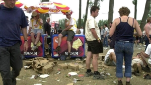 Music fans pictured between a lot of rubbish on the last eve of the "Rock Werchter" open air festival in Werchter. (BELGA PHOTO OLIVIER MATTHYS)
